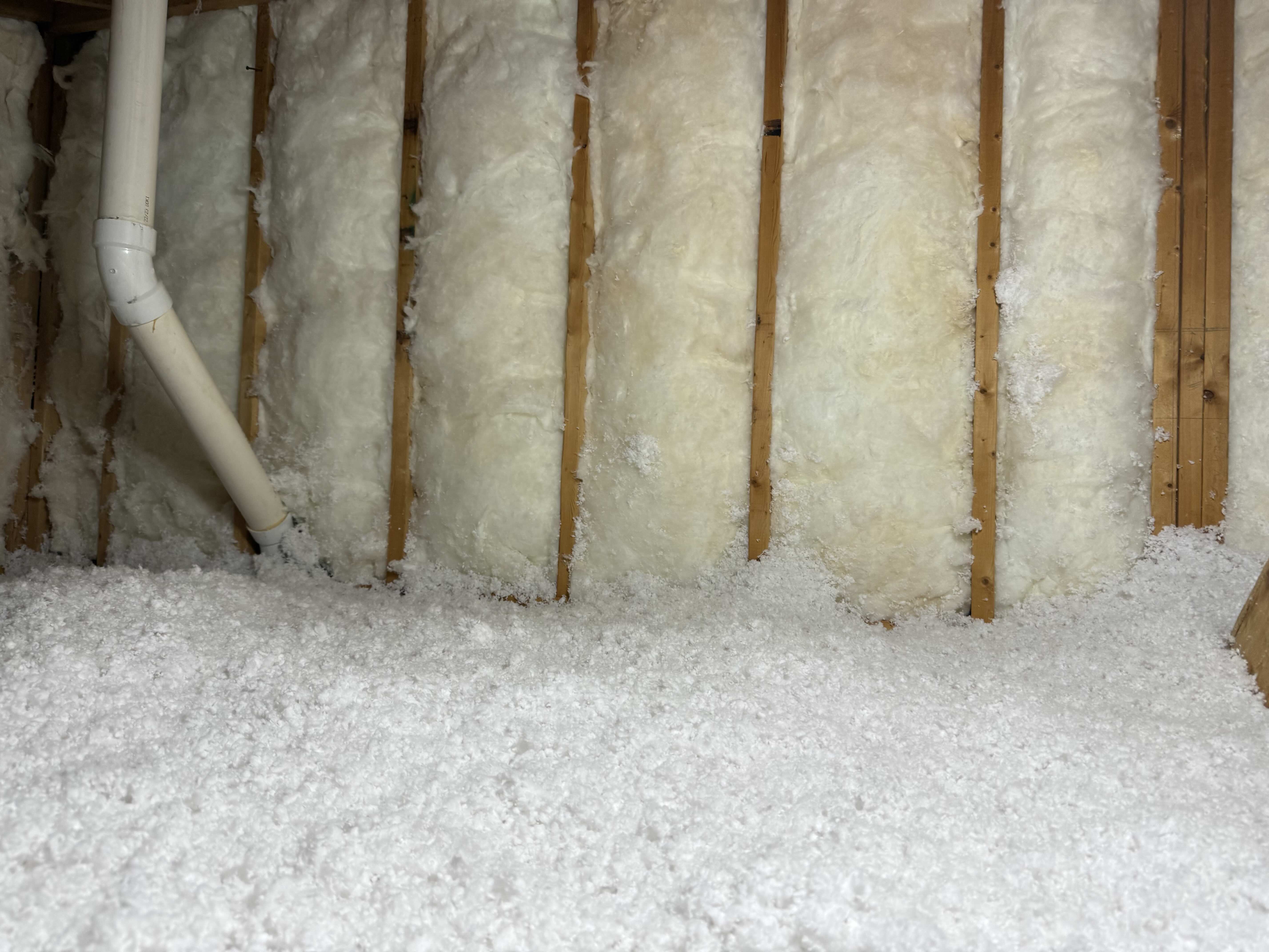 New fiberglass batt insulation in attic knee walls after full remediation