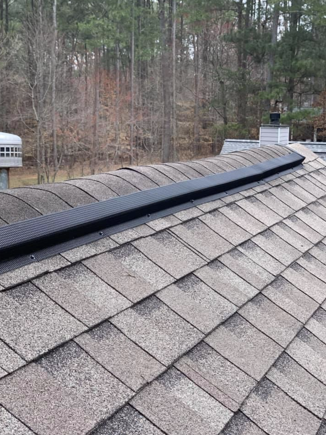 Professional metal ridge vent installation on a home in the North Georgia mountains